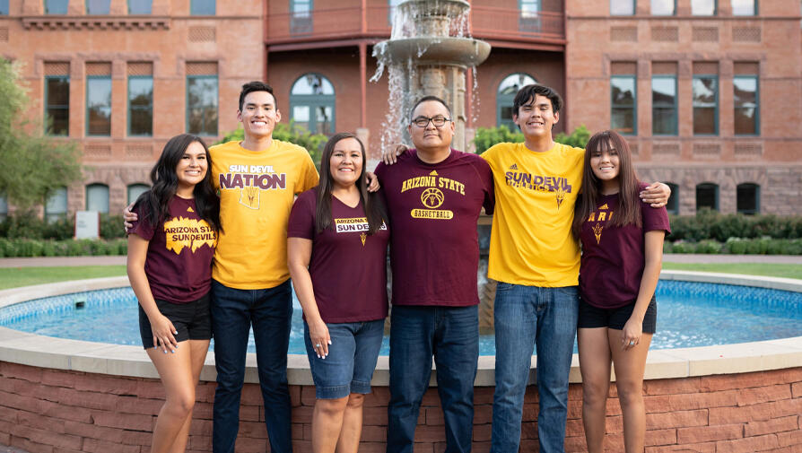 family in front of old main